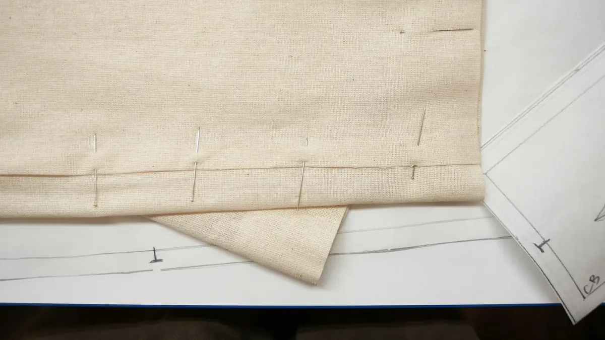 Fabric marked with pins for sewing