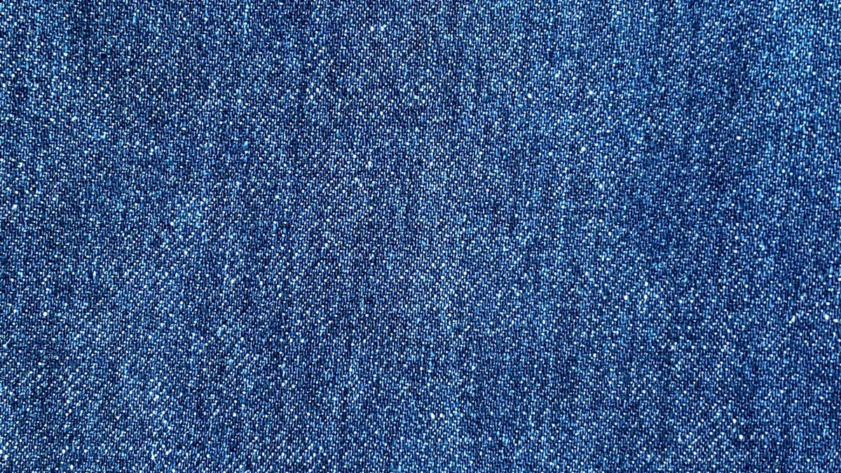 A close up of a blue jean fabric