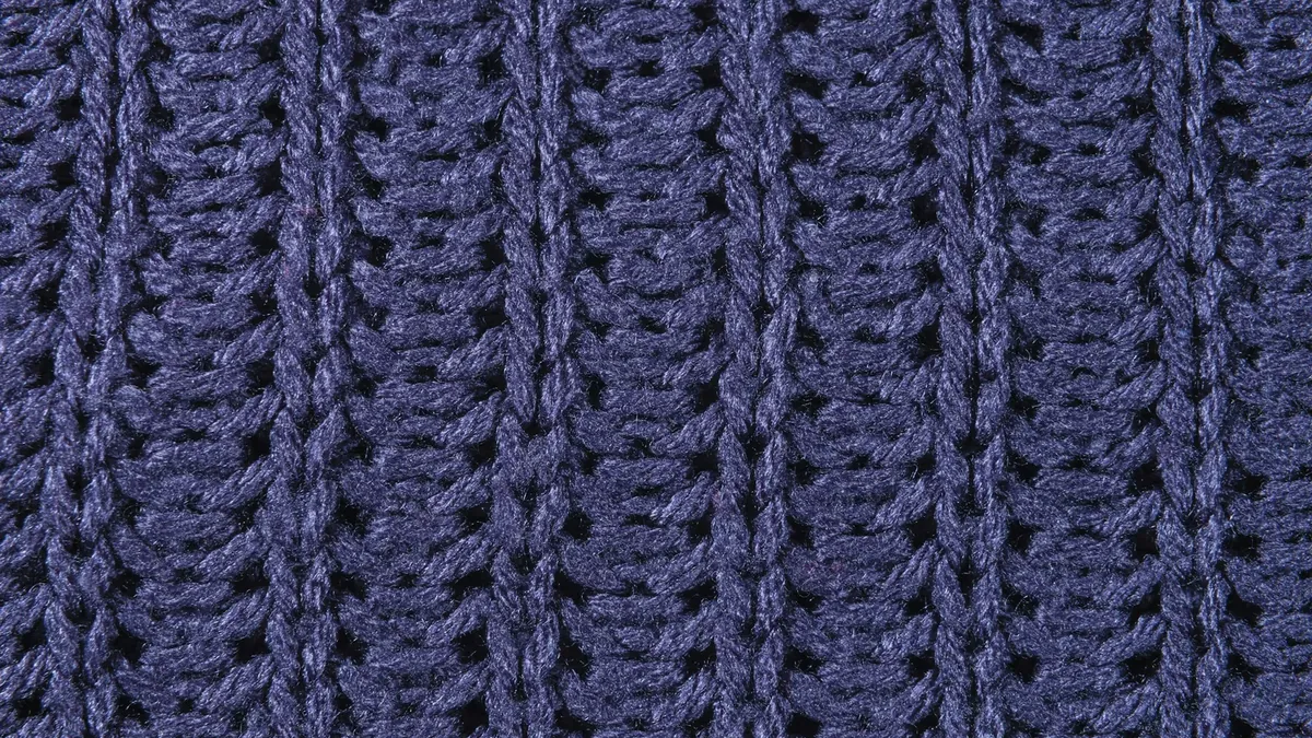 A close up of a blue knitted blanket