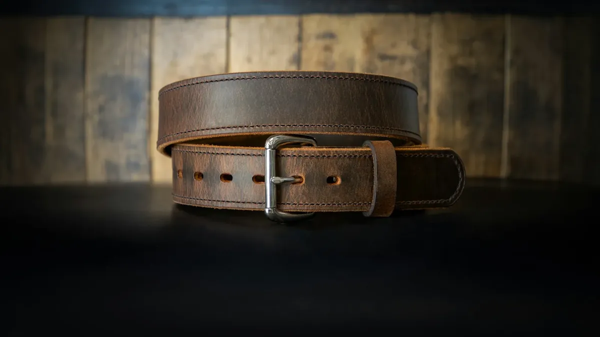 A leather belt on a black surface