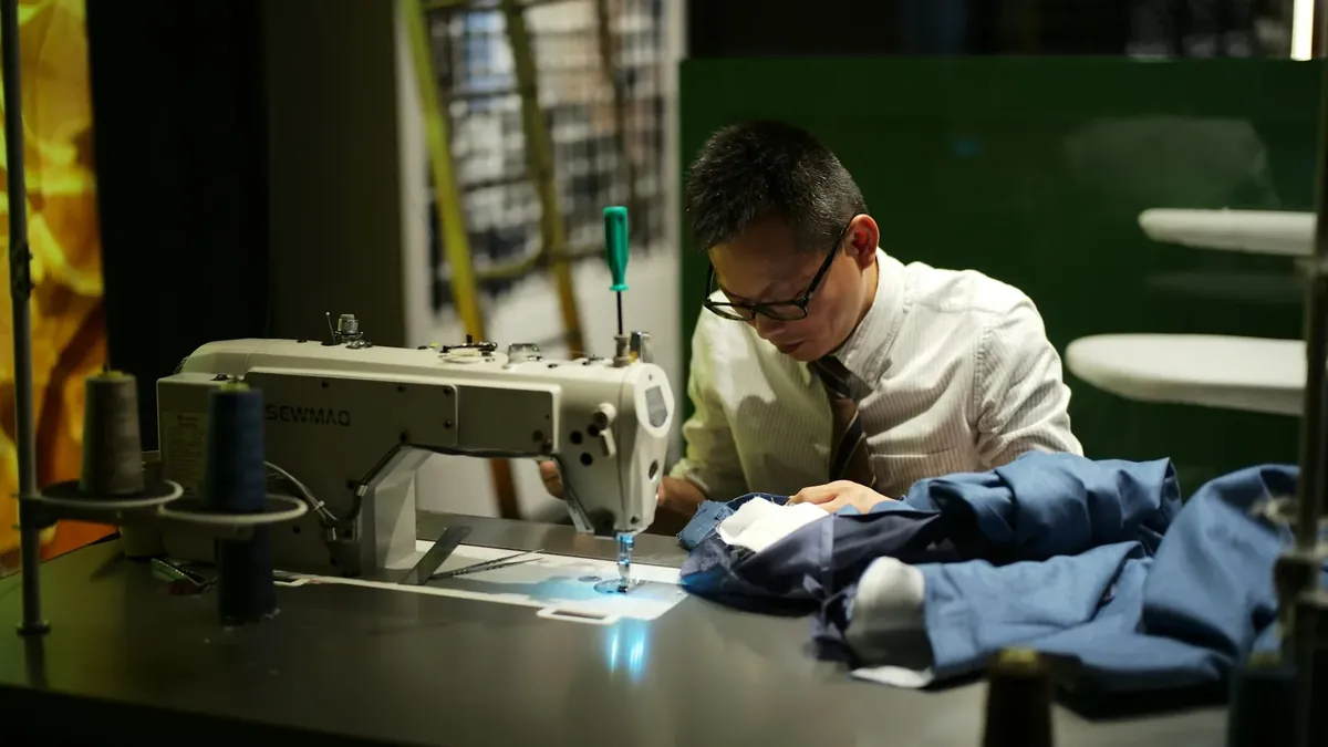 Man sewing clothes at a machine