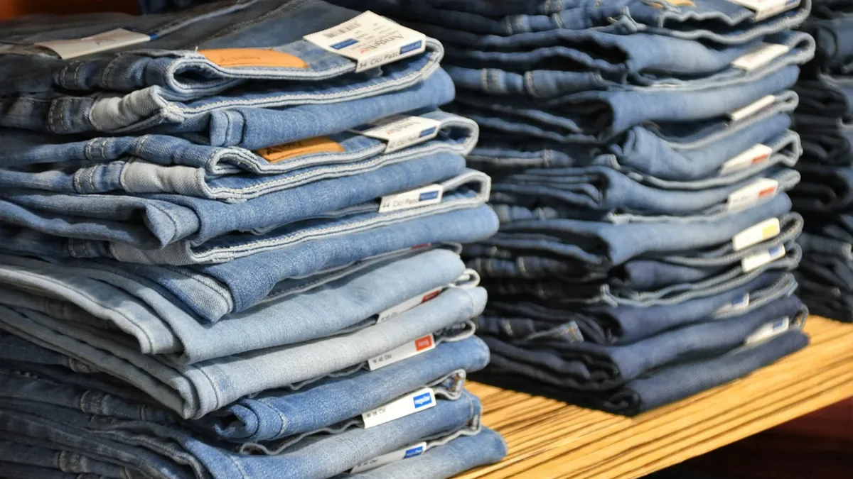 Pile of blue denim jeans lot