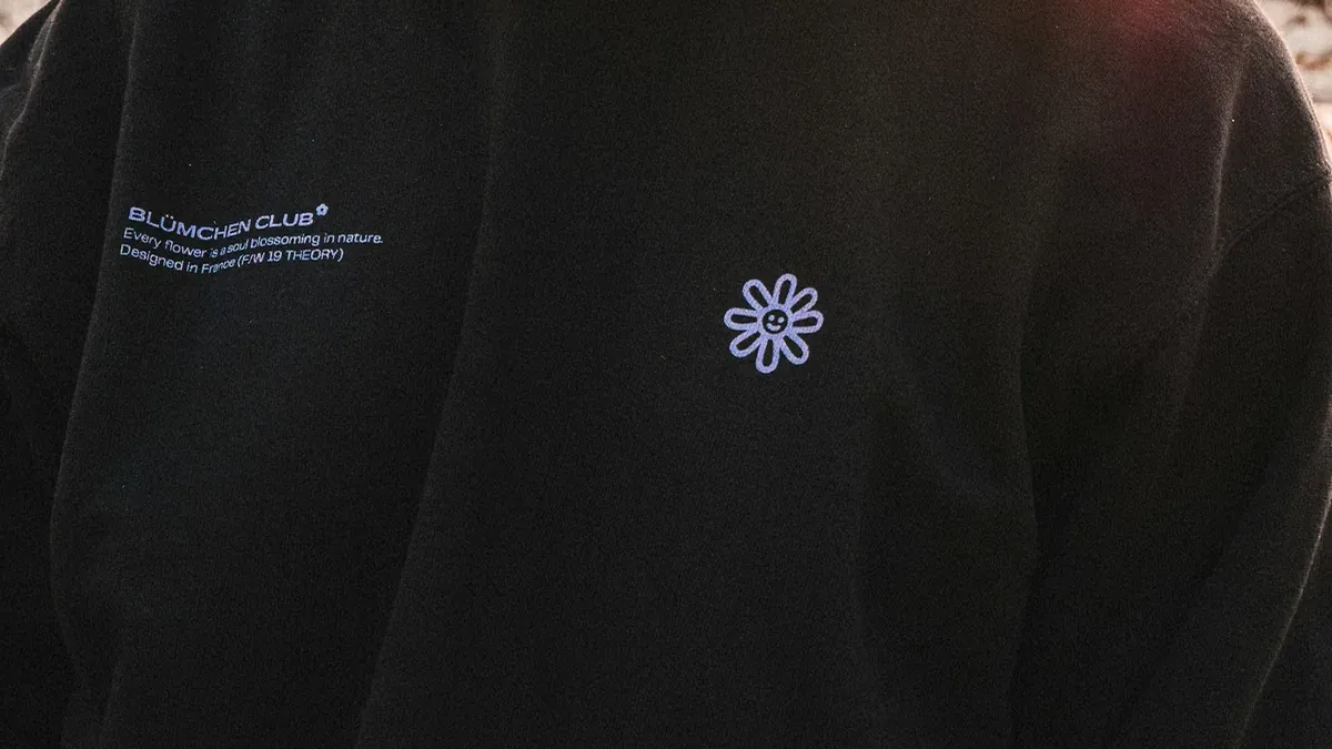 Woman wearing black with white printed crew-neck sweatshirt standing while facing her left side