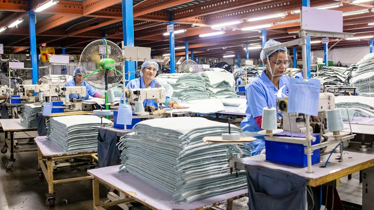 Workers are sewing textiles in an industrial factory