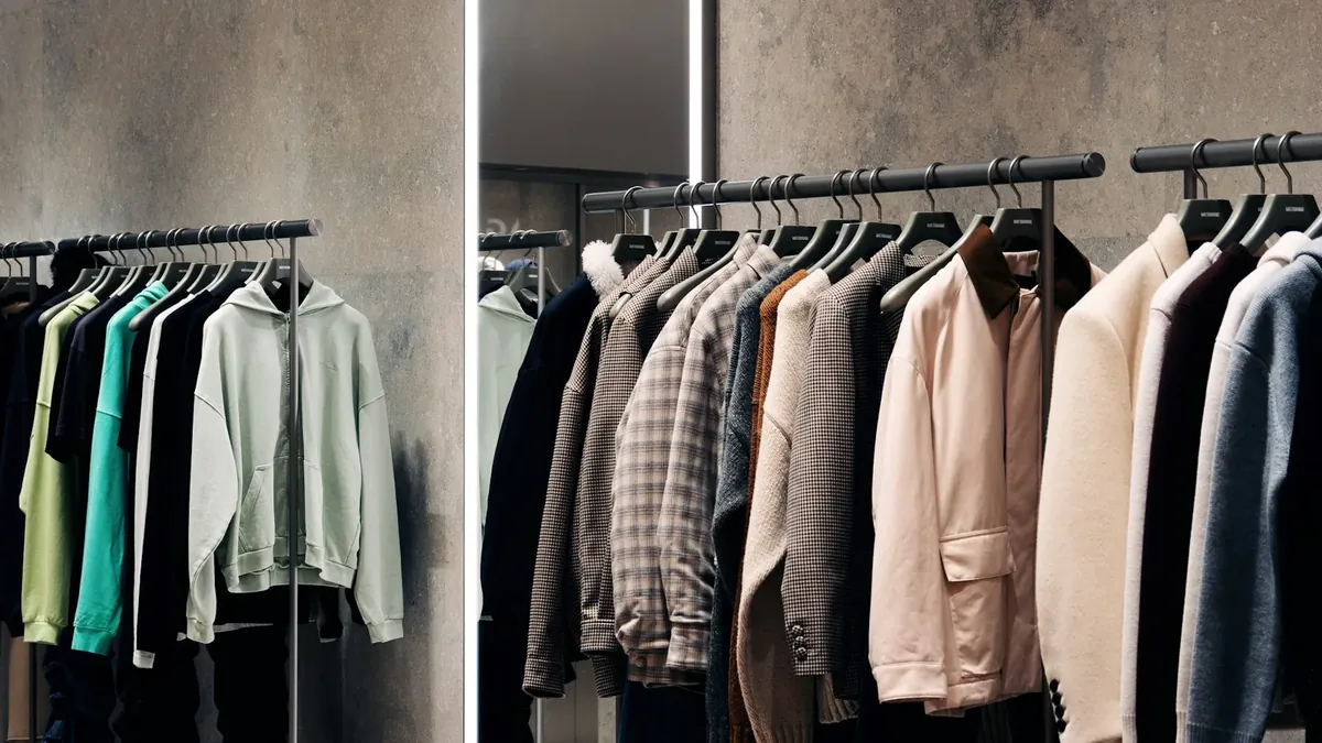 A rack of shirts and pants in a store