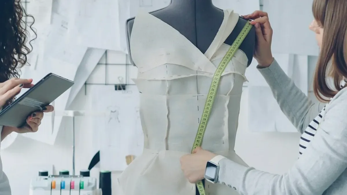 Fashion designers working on a garment in their studio