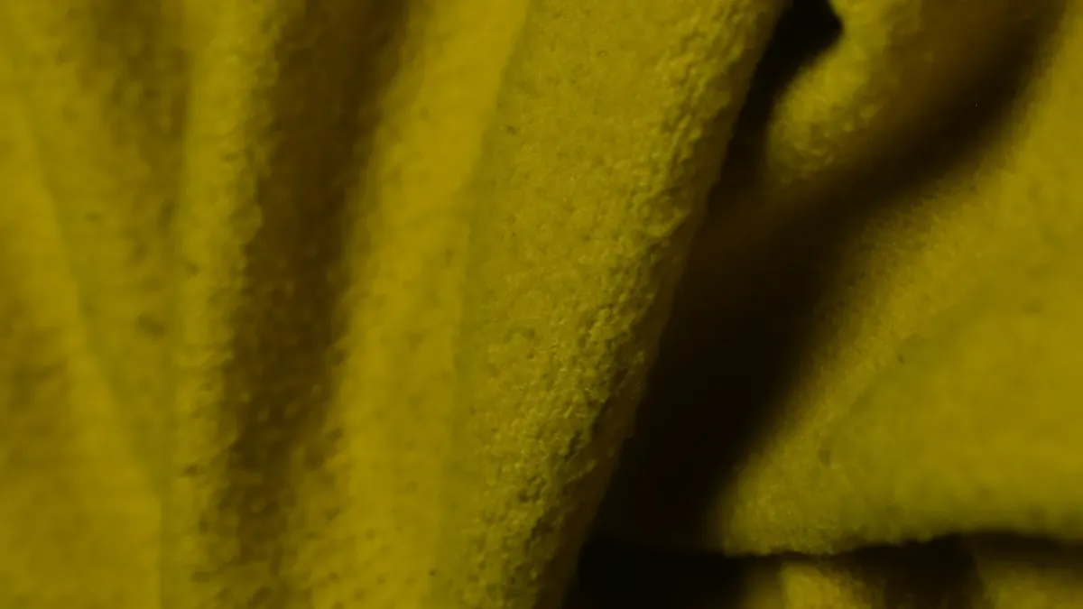 Textured yellow fabric folds with soft lighting