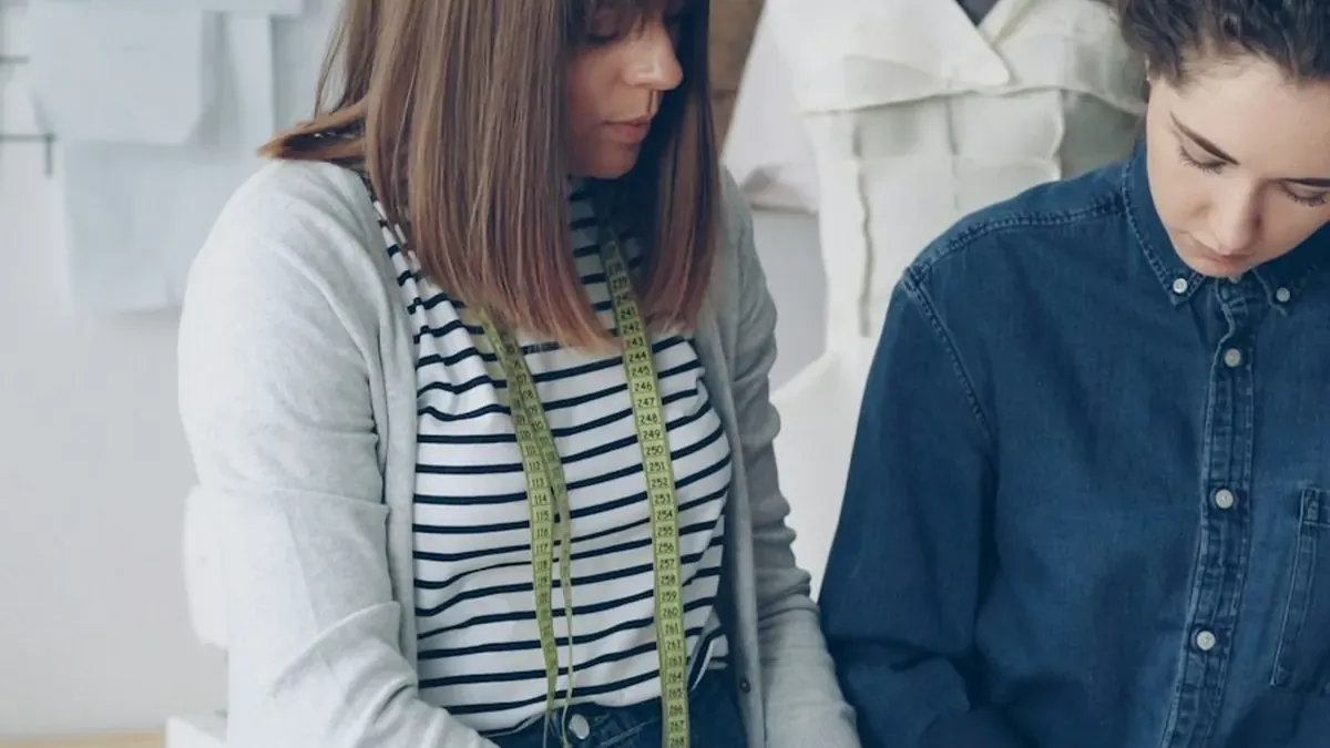 Fashion designers collaborating on garment patterns