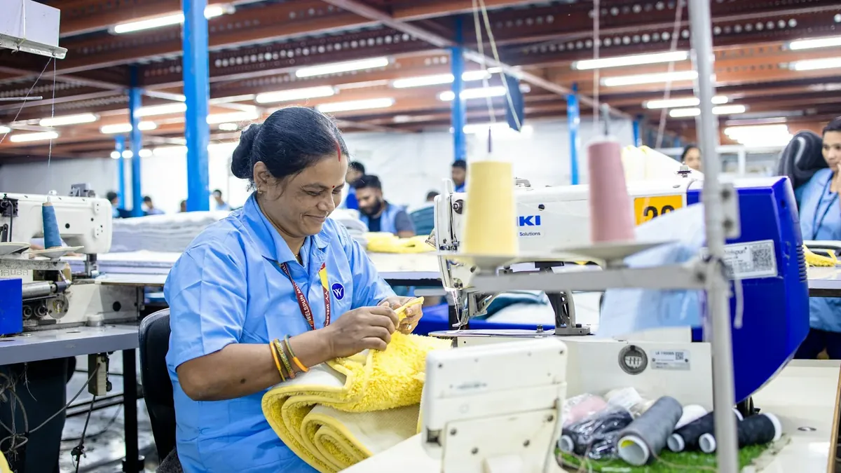 Woman sewing garments in a textile factory
