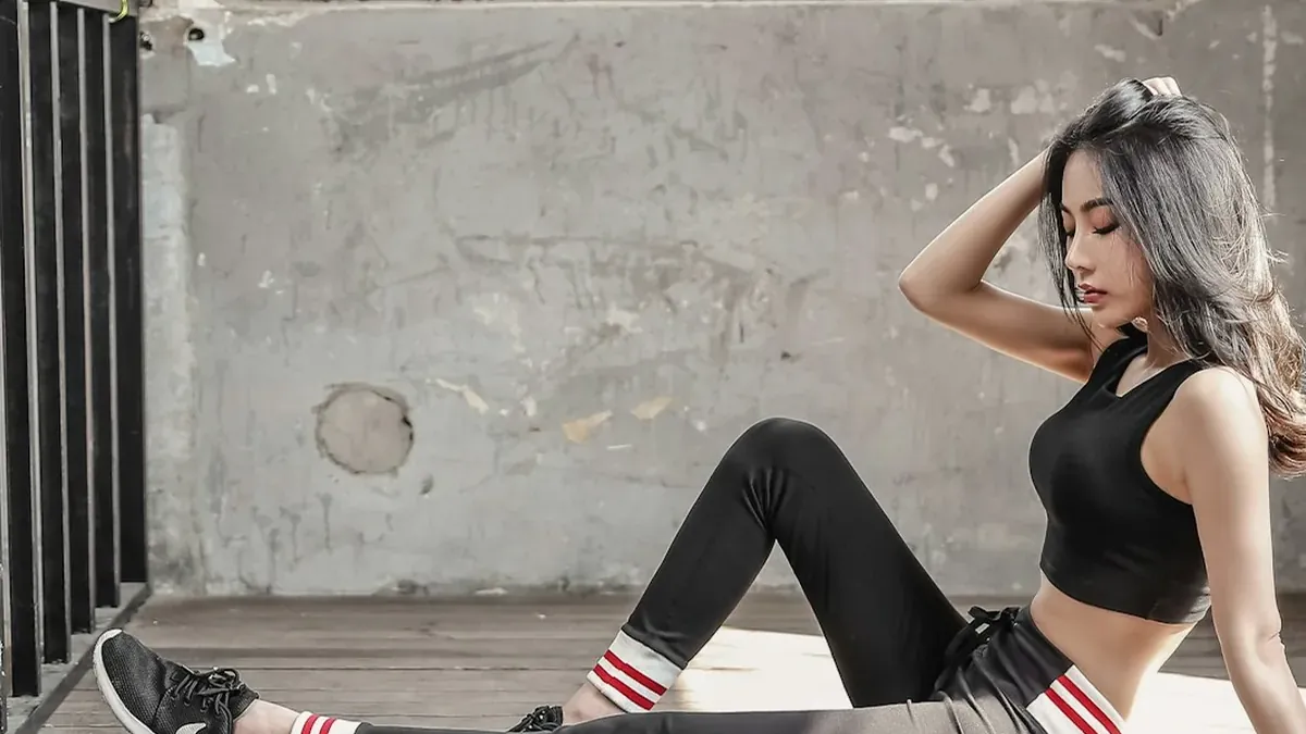 Woman in black sports bra and black leggings doing yoga