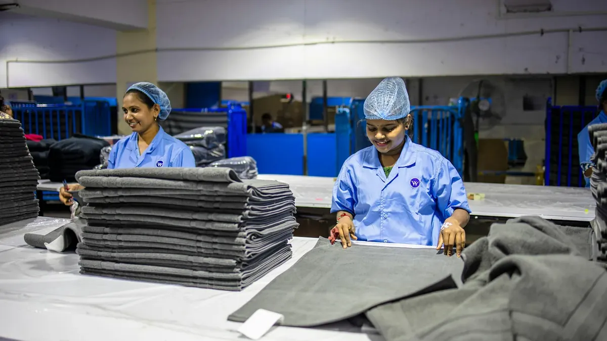 Workers folding textiles in a factory