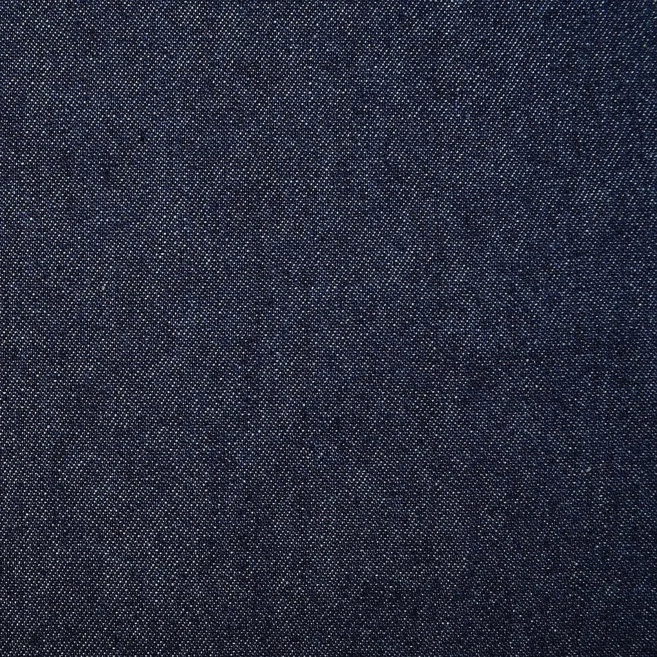 A close study of deep indigo denim with a crisp diagonal twill surface.