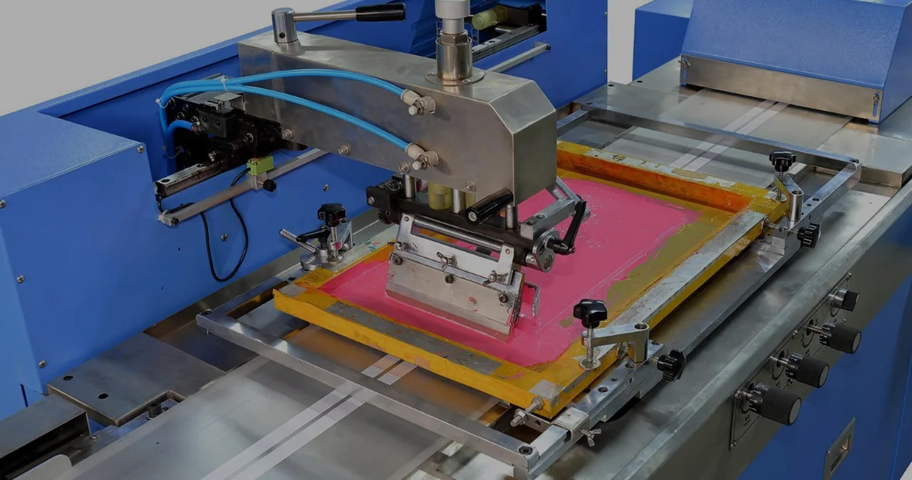 Blue screen-printing equipment with a pink ink screen.