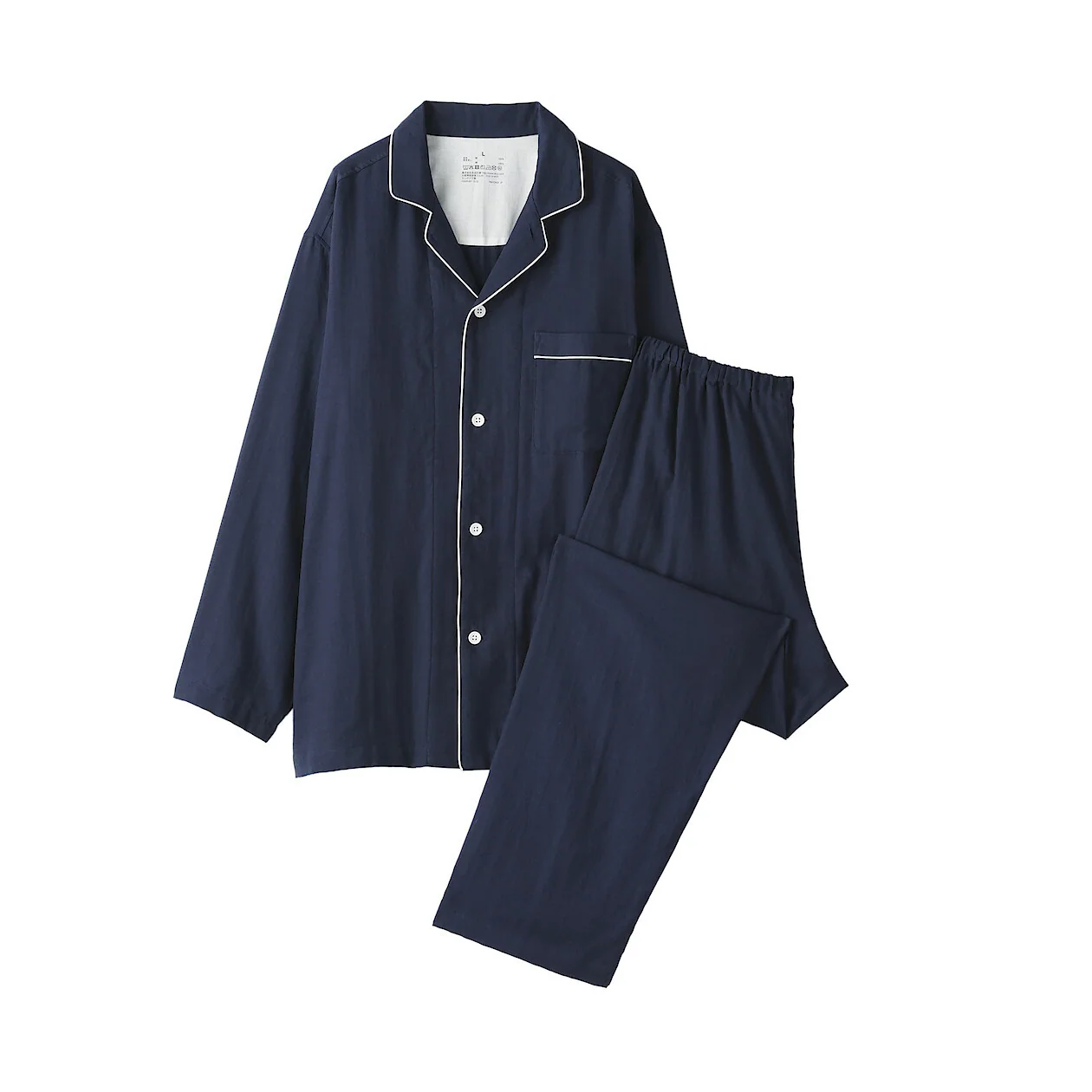 Camisa de pijama azul marino con vivos en contraste, colocada junto a los pantalones a juego doblados sobre un fondo blanco.